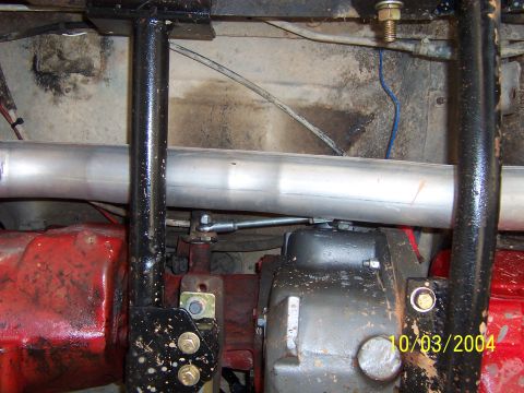 1978 Ford Bronco - A close-up of vehicle undercarriage components, including a large exhaust pipe and transmission housing, is visible.