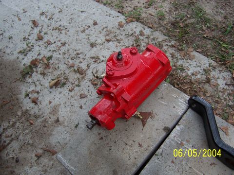 1978 Ford Bronco - A red steering gear box is shown on concrete with leaves scattered around. The date 06/05/2004 is visible in the lower right corner.