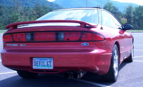 1996 Ford Probe - Rear view of a red 1996 Ford Probe GT, showing its distinctive taillights and spoiler.