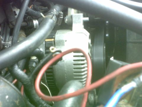 1992 Ford Bronco - Alternator and wiring detail within an engine compartment.