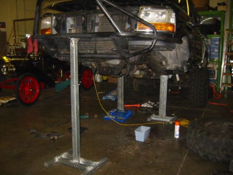 1992 Ford Bronco - Front view of a 1992 Ford Bronco undergoing work on shop lifts.