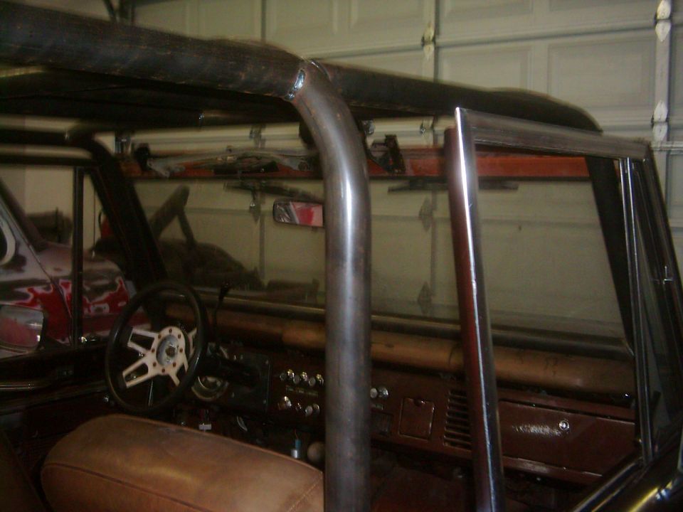 1978 Ford Bronco interior with custom roll cage and brown seats