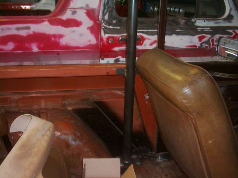 1978 Ford Bronco - The interior of a vehicle shows signs of bodywork and a roll cage installation, with brown seats visible.