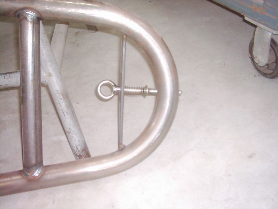 Close-up of a metal tube door frame with a spring-loaded pin mechanism