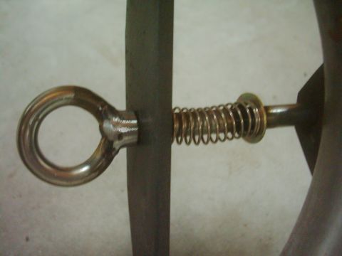 1978 Ford Bronco - Door latch mechanism with spring and eyelet, likely a replacement part.