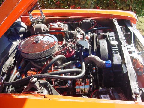 1969 Ford Ranchero - Close-up view of a modified engine bay, custom hoses and chrome accents.