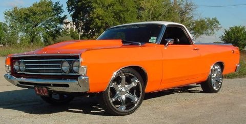 1969 Ford Ranchero - This 1969 Ford Ranchero is painted bright orange with a white roof and features a prominent aftermarket hood scoop.