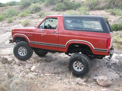 1984 Ford Bronco - 1984 Ford Bronco navigating a rocky trail.