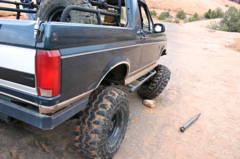 1993 Ford Bronco - Rear view of a modified Ford Bronco on a rocky trail.