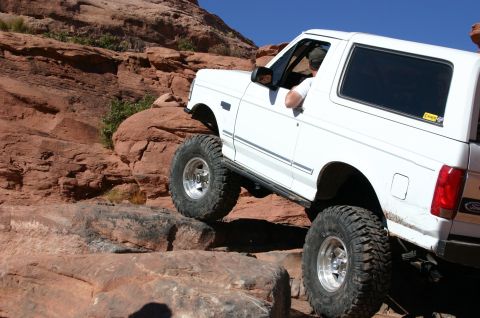 1993 Ford Bronco - This 1993 Ford Bronco navigates a rocky off-road course under a clear blue sky.