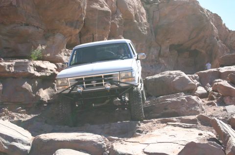 1993 Ford Bronco - 1993 Ford Bronco tackling rough terrain in a rocky canyon.