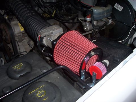 1994 Ford Bronco - Aftermarket air intake system installed in the engine bay, a red cone filter.