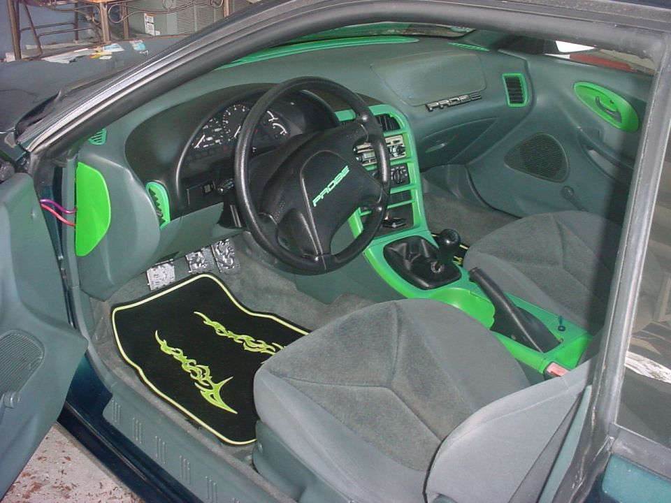 Ford Probe interior with green-painted trim and black tribal floor mat