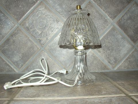 1987 Volkswagen Golf - A glass table lamp with a fluted shade and a decorative base is shown on a tiled surface.