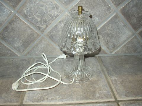 1987 Volkswagen Golf - A decorative glass lamp with a fluted shade and etched floral details sits on a tiled surface, complete with its white power cord.