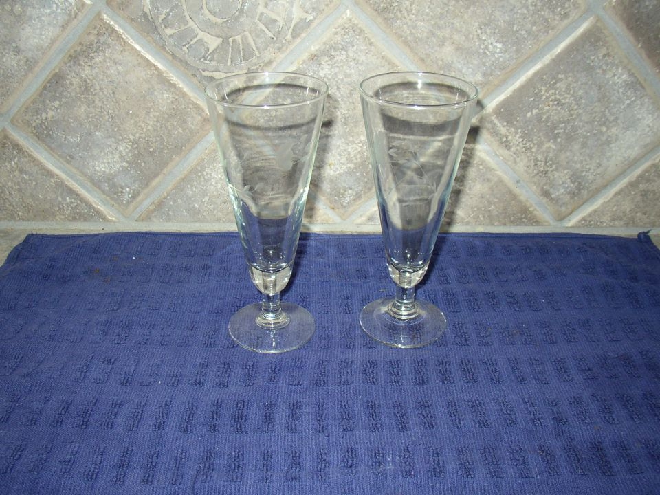 two tall clear glasses on a blue towel