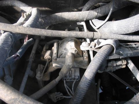 1988 Ford Bronco - A close-up view of an engine compartment shows a distributor cap and associated wiring and hoses.