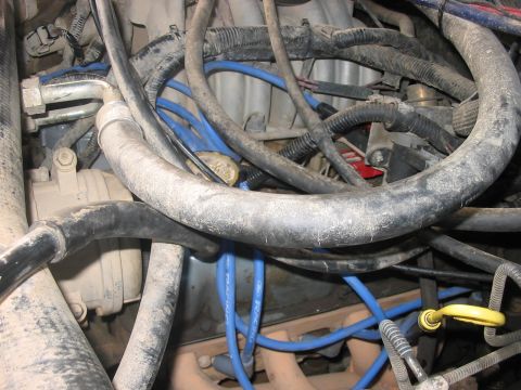 1988 Ford Bronco - Close-up view of a dusty engine bay, showing various wires and hoses.
