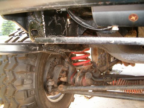 1979 Ford Bronco - Close-up view of the undercarriage of a vehicle, highlighting its suspension and steering systems.