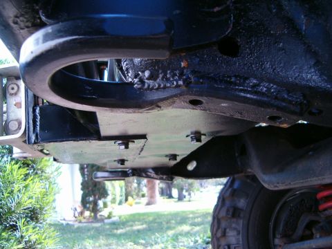 1979 Ford Bronco - Close-up view of a vehicle's undercarriage, showing a tow hitch and protective skid plate.