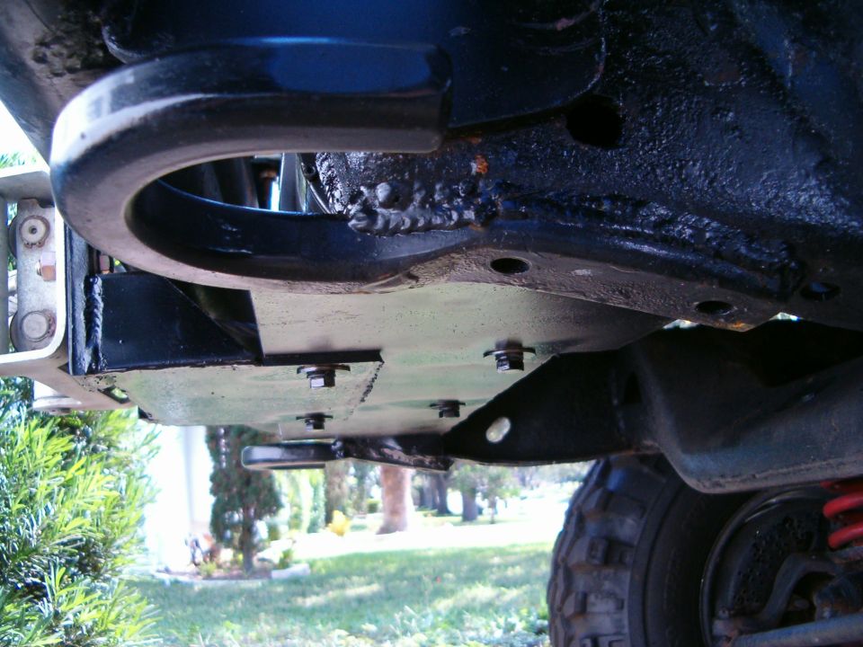 Undercarriage view of a vehicle's tow hitch and skid plate