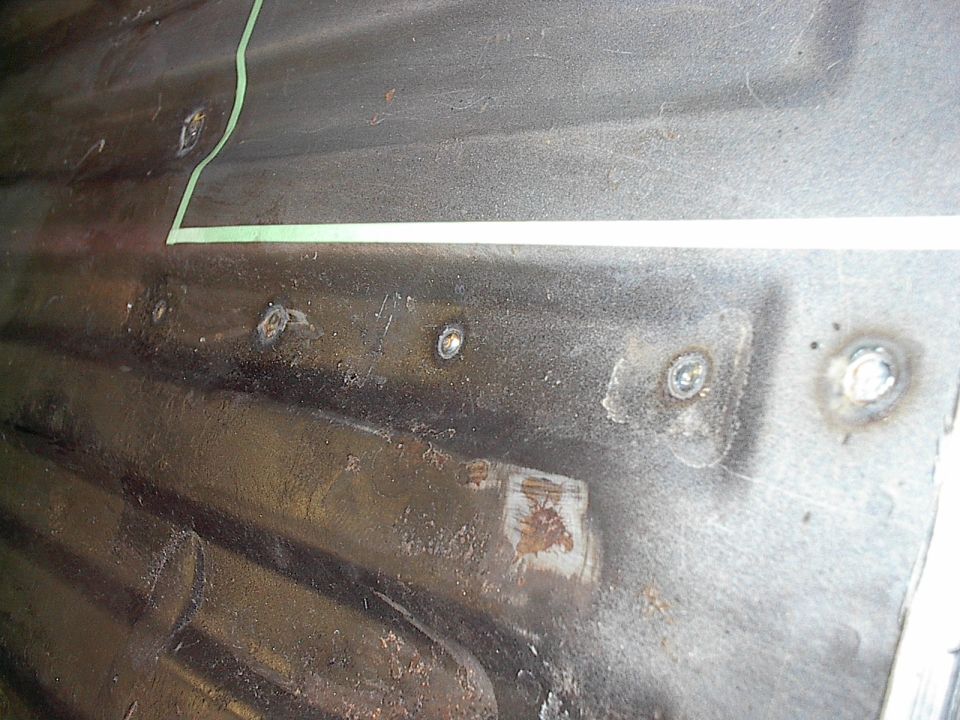 By drilling holes in the floor you are able to button weld the box's flanges to the floor from above instead of having to weld upside down.  Seal sealer makes sure none of the edges underneath leak.