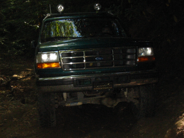 Green 1996 Ford Bronco front view with roof lights