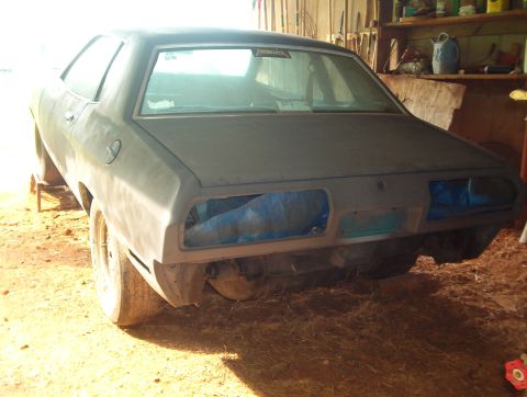 1977 Ford Mustang II - July 16-04. Half of the car sanded to bare metal and primered.