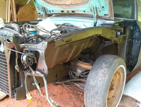 1977 Ford Mustang II - Front end of a car undergoing restoration, with engine components visible.