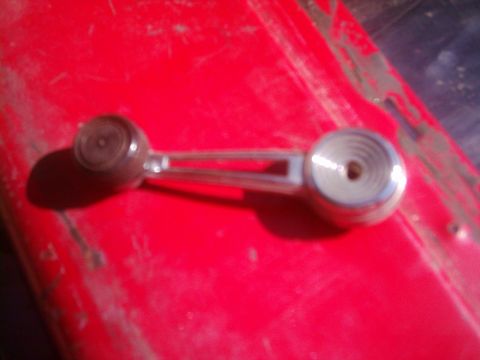 1978 Ford Bronco - Close-up of a vintage window crank handle, likely for a car door interior.