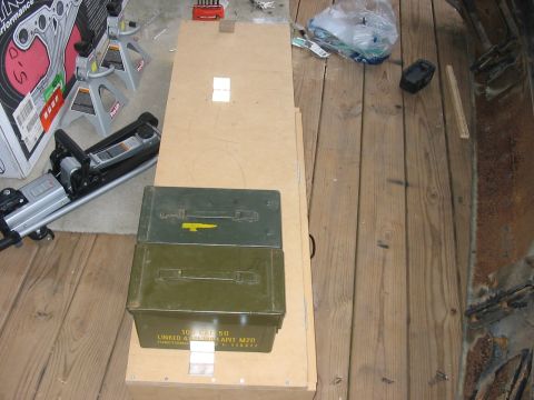 1988 Ford Bronco - Two green ammo cans are stacked on a wooden surface, with a car jack and other items in the background.