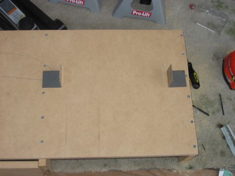 1988 Ford Bronco - Wooden panel with metal brackets, likely part of a storage solution or custom build.