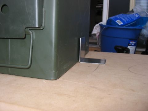 1988 Ford Bronco - A green ammo can is shown with a metal L-bracket attached to its side.
