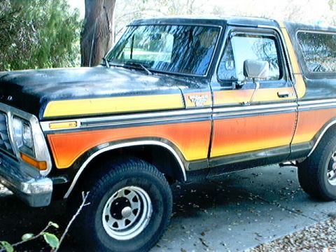 1979 Ford Bronco - This Ford Bronco has a two-tone paint scheme with orange and yellow stripes along the body.