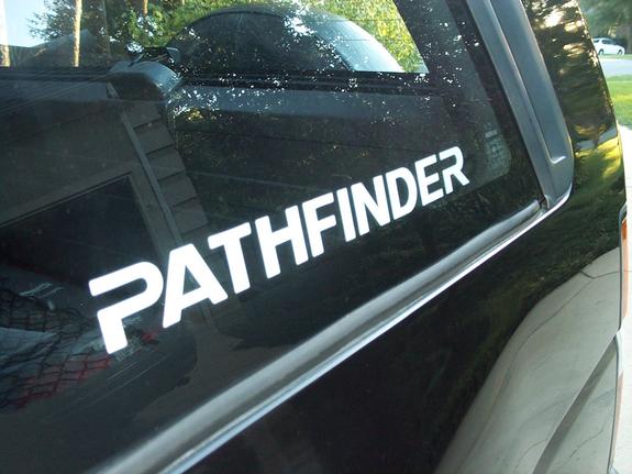 White PATHFINDER decal on rear side window of black Nissan Pathfinder SUV