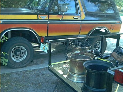 1979 Ford Bronco - This 1979 Ford Bronco features a distinctive orange and yellow striped paint scheme on its side.