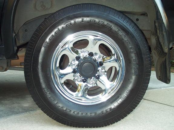 Chrome six-spoke wheel with BFGoodrich Radial Long Trail T/A white-letter tire on a dark vehicle