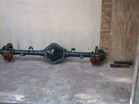 1979 Ford Bronco - Rear axle assembly with disc brakes, likely from a truck or SUV, displayed on a concrete floor.