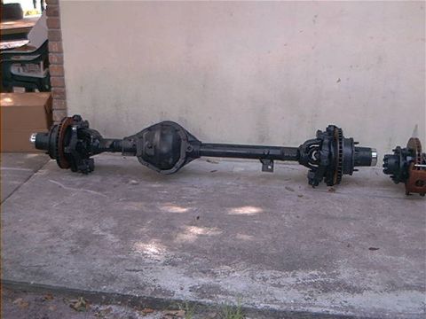 1979 Ford Bronco - Ford rear axle assembly with disc brakes and differential housing shown on concrete.