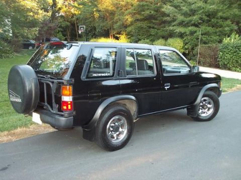 1995 Nissan Pathfinder - Rear-quarter shot in the street.