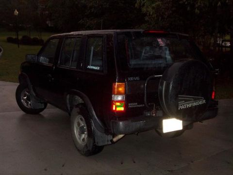 1995 Nissan Pathfinder - Rear view of a black 1995 Nissan Pathfinder, a spare tire mounted on the tailgate and "PATHFINDER" badging.