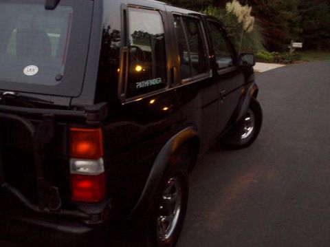 1995 Nissan Pathfinder - Rear view of a black 1995 Nissan Pathfinder parked on a paved surface.