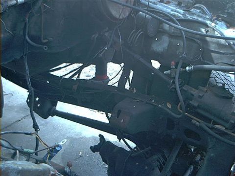 1979 Ford Bronco - Undercarriage view of a vehicle, showing exposed mechanical parts and wiring.