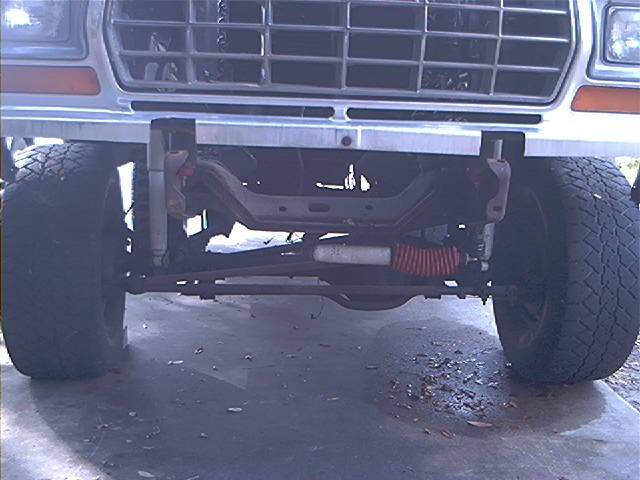 front end of a lifted truck, showing grille, bumper, and suspension components