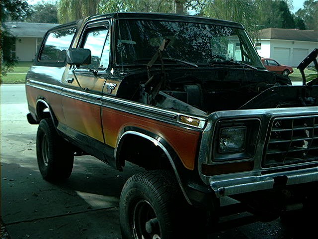 1979 Ford Bronco 3q front view, hood open, orange and black paint
