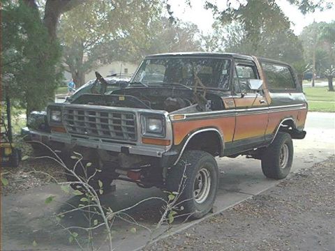 1979 Ford Bronco - This 1978 Ford Bronco is parked outside with its hood up, showing the engine compartment.