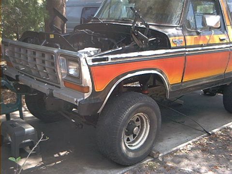 1979 Ford Bronco - This Ford Bronco is parked outdoors with its hood up, revealing the engine compartment.