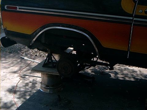 1979 Ford Bronco - Rear axle of a 1979 Ford Bronco is suspended on jack stands for maintenance.
