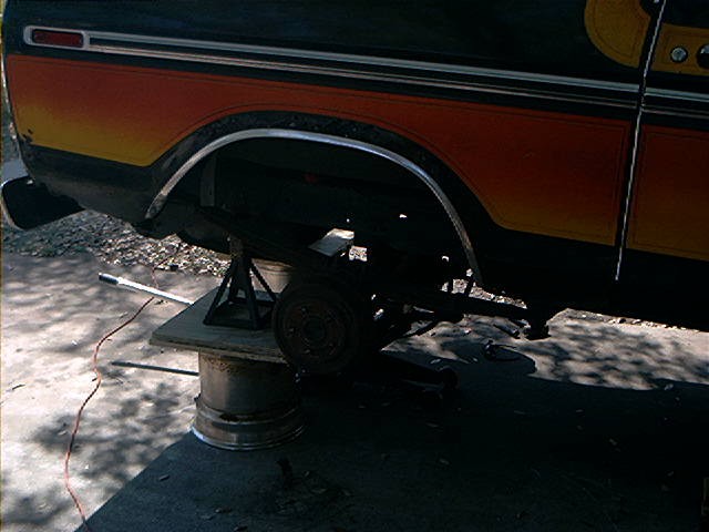 1979 Ford Bronco rear axle assembly removed and supported by jack stands