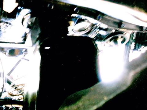 1979 Ford Bronco - The engine bay of a 1979 Ford Bronco shows various mechanical parts and wiring.